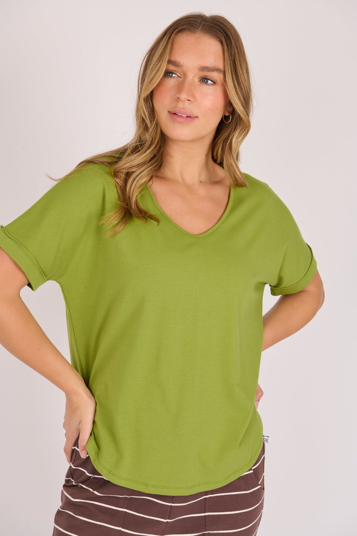 One Ten Willow V neck curve hem tee in green, front view