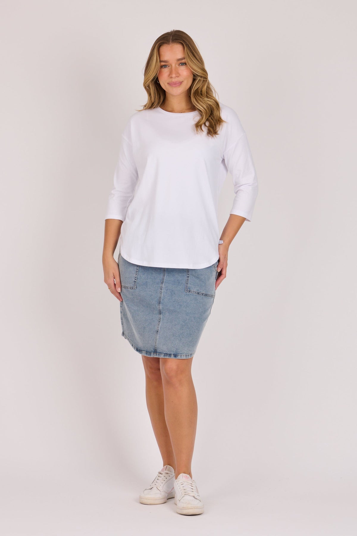 One Ten Willow Scoop Hem Top in white, full length styled with a denim skirt