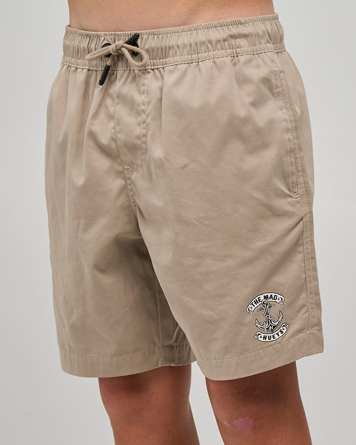 The Mad Hueys Skull Anchor Youth 16 inch Volley Short in taupe - worn