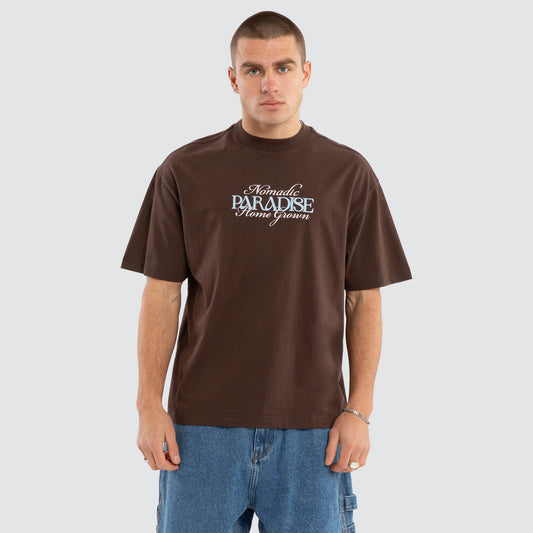 Man wearing a brown t-shirt with text on a plain background