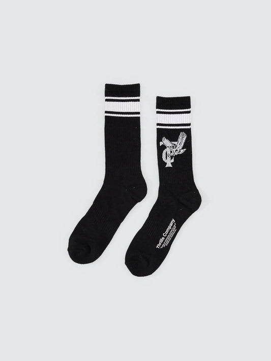 Black socks with white stripes and a logo on a light gray background